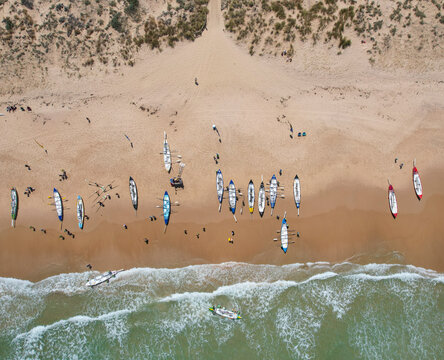 Aerial view of rowing boat race at sandy Port Noarlunga Beach with beautiful coastline and ocean, Adelaide, Australia.