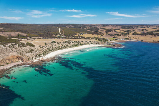 Aerial view of serene Stokes Bay Beach with clear blue water and picturesque coastline, Stokes Bay, Australia.