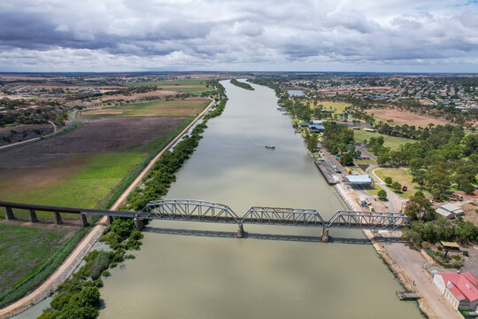 Aerial view of the beautiful Old Murray River with a scenic bridge and expansive fields, Murray Bridge, Australia.