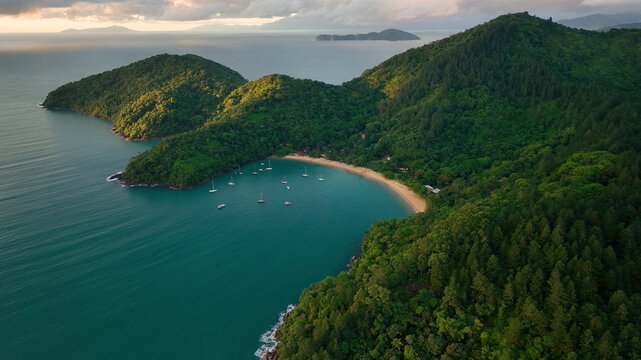 Aerial view of tropical archipelago with serene islands and sailboat in the ocean, Angra dos Reis, Brazil.