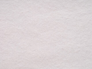 Subtle elegance of a pale pink felt surface, evoking softness and calm in its simplicity