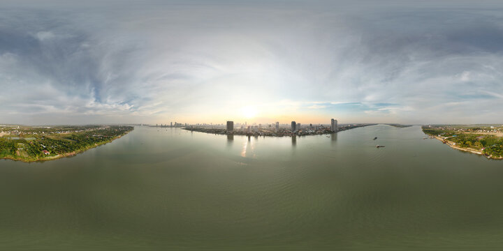 Aerial view of serene cityscape with expansive river and tranquil skyline under daylight, Svay Chrum, Cambodia.
