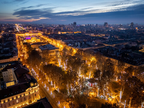 Aerial view of zrinjevac park with christmas market and vibrant city lights at night, zagreb, croatia.