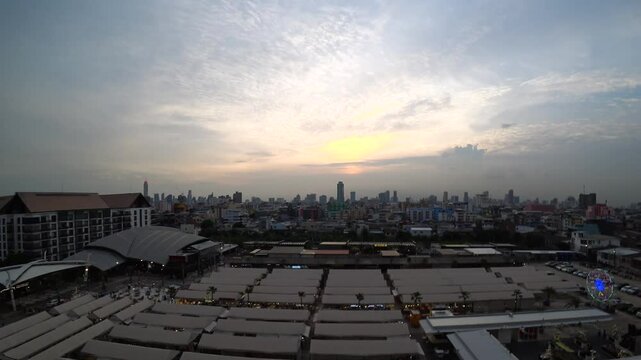 BANGKOK, THAILAND - AUGUST 2024 : View of &ldquo;The One Ratchada night market&rdquo; in sunset. High angle 4K time lapse shot, dusk to night.