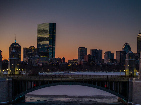 Aerial view of beautiful skyline featuring the John Hancock Building and Prudential Building along the Charles River at sunset, Boston, United States.
