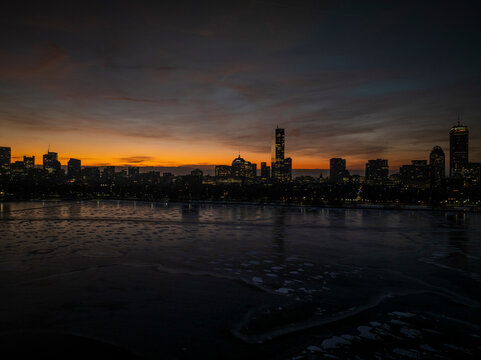 Aerial view of boston skyline at sunset with charles river, john hancock building, and prudential center, boston, united states.