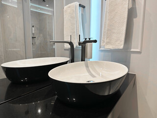 Stylish sink near mirror in hotel bathroom