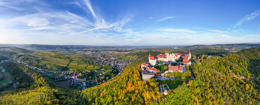 Aerial view of Stift Goettweig monastery and church surrounded by autumn vineyards and forests, Krems, Austria.