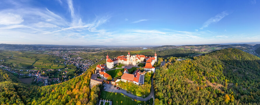 Aerial view of picturesque Stift Goettweig monastery surrounded by autumn trees and hills, Krems, Austria.