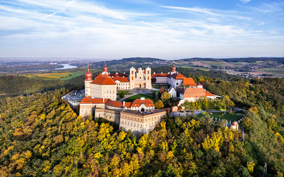Aerial view of the historic Stift Goettweig monastery and church surrounded by vibrant autumn foliage and serene hills, Krems, Austria.