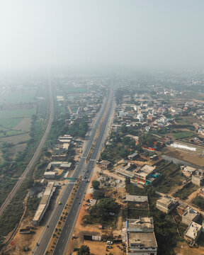 Aerial view of urban landscape with expressway and modern buildings, Fatehpur Sikri, India.
