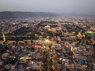 Aerial view of the vibrant Pink City with historic architecture and the City Palace, Jaipur, India.