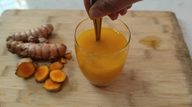 Organic Turmeric Powder Stirred in Water to Make Healthy Drink, Ayurvedic Health Drink, Healthy drink, Turmeric drink making, 4K.