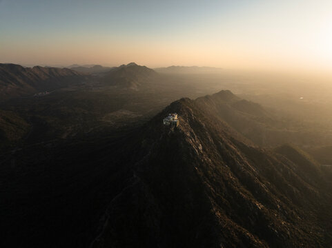 Aerial view of Shree Savitri Mata Temple on a mountain at sunset, Pushkar, Rajasthan, India.