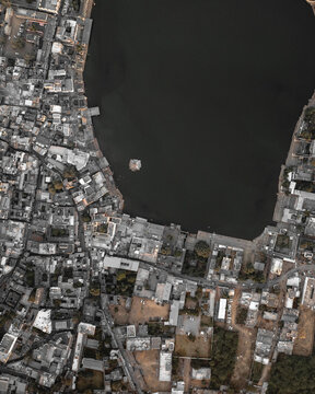 Aerial view of densely populated cityscape with buildings and a lake, Ajmer, Rajasthan, India.