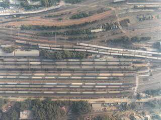 Aerial view of beautiful railway station with trains and tracks in urban landscape, Ajmeri Gate, New Delhi, India.