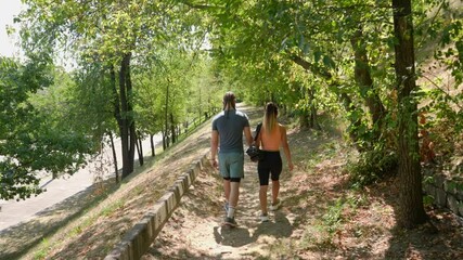 Active young couple in sportswear enjoying an outdoor walk.