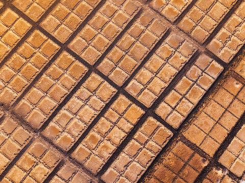 Aerial view of beautiful salt flats with unique patterns and textures, Teguise town, Canary Islands, Spain.