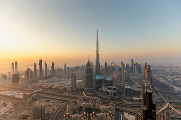Aerial view of burj khalifa towering over the beautiful cityscape at sunset, dubai, united arab emirates.