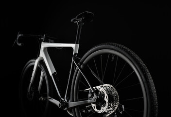 Rear View of Black and White Gravel Bike on Black Background