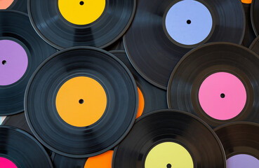 Colorful vinyl records background. Music themed designs, retro party promotions, or nostalgic audio equipment advertisements.
