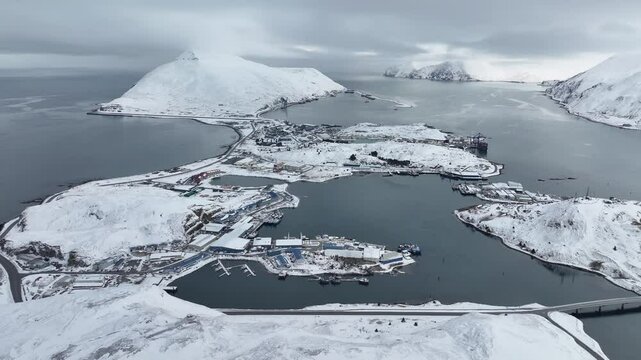 Aerial view of carl mosses harbor surrounded by snowy mountains and calm sea, unalaska, united states.