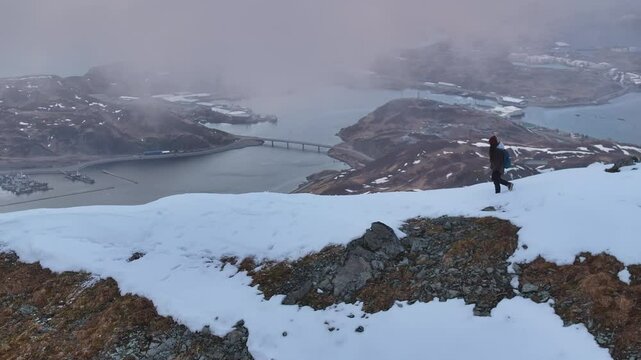 Aerial view of majestic snowy mountain with a person hiking, Unalaska, United States.