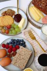 Assortment of various breakfast foods and drinks on the white table. Selective focus.