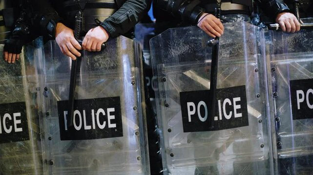 Police officer team with weapons and riot shield protection. Violence Against Demonstrators and protesters. Tbilisi. Georgia.