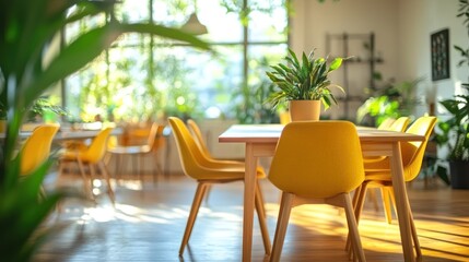 Obraz premium Sunny cafe interior, plants, yellow chairs, wooden table, sunlight