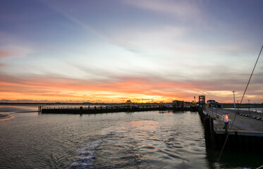 Obraz premium Landscape near Dagebüll harbor. Nature with sunrise on the North Sea coast. Rising sun on the sea. 
