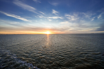 Landscape near Dagebüll. Nature with sunrise on the North Sea coast. Rising sun on the sea.
