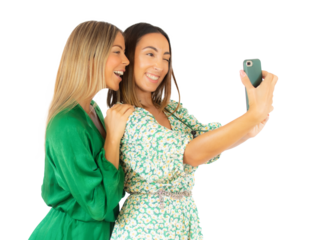 Two young women taking a selfie together standing isolated over transparent background. PNG transparent.