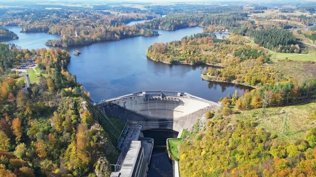 Aerial view of tranquil Stausee Ottenstein water reservoir surrounded by autumn foliage and serene forest, Zwettl, Austria.