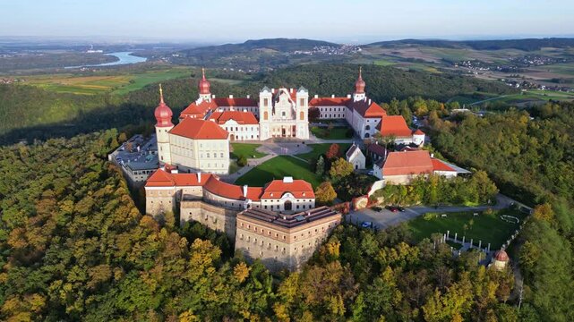Aerial view of Stift Goettweig monastery and church surrounded by autumn foliage and scenic hills, Krems, Austria.