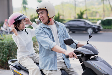 Naklejka premium Dad drives his daughter on his motorbike to school 