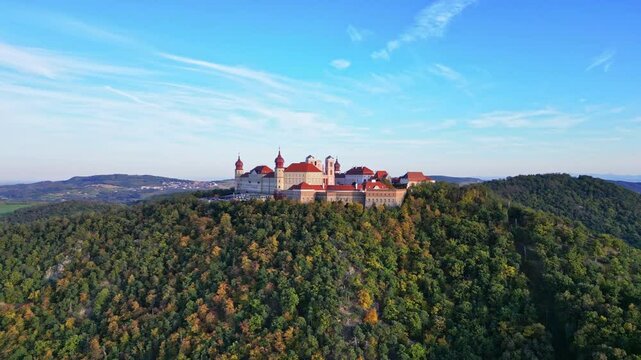 Aerial view of Stift Goettweig monastery and castle surrounded by autumn hills and forest, Krems, Austria.