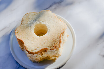 Hommade angel food cake light and fluffy sponge cake made with egg whites served with whipped cream and strawberry.