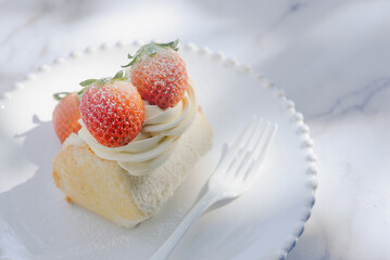 angel food cake light and fluffy sponge cake served with whipped cream and strawberry on white plate.