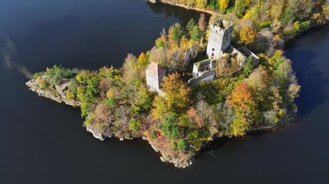 Aerial view of the tranquil Stausee Ottenstein with a picturesque castle ruin surrounded by autumn foliage, Zwettl, Austria.