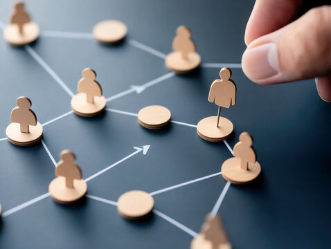 Manager placing wooden pawn representing new employee in organizational chart