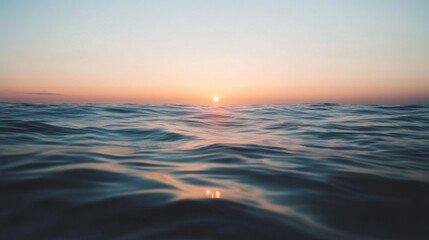Obraz premium Serene ocean sunrise with tranquil waves under scenic sky