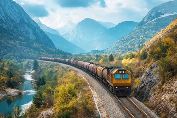 Cargo train navigating through rocky mountains scenic landscape nature photography majestic environment wide-angle viewpoint freight transport concept