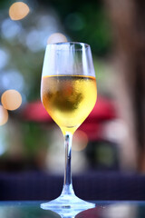a glass of white wine served in a restaurant, abstract background of a summer restaurant