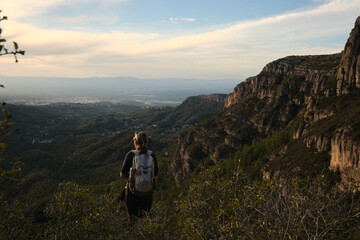 A woman from the back descending from the mountain