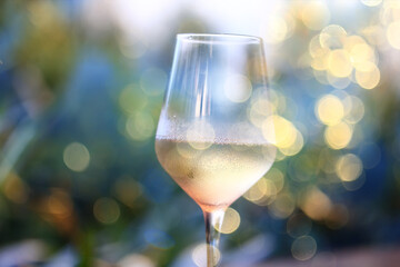 A glass of white wine on a blurred abstract background, alcohol, relaxation