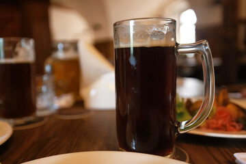A mug of cold beer in a bar with a blurred background