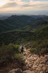 A woman from the back descending from the mountain