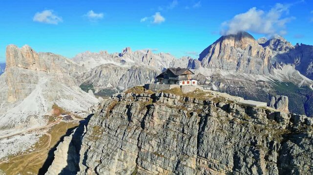 Aerial view of the scenic Dolomites with a mountain hut at the summit of Monte Nuvolau, Cortina d'Ampezzo, Italy.