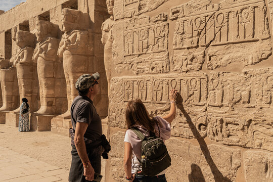 Tourist couple visiting Karnak Temple in Luxor. Family trip to Egypt. Photography for travel agency.